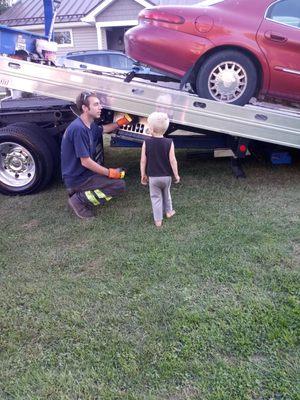 Tow truck delivery driver and his truck