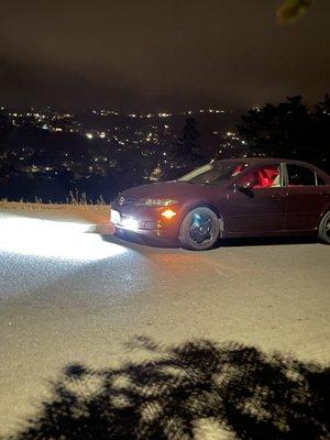 My Mazdarati with the night view of the city in the background