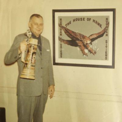 John M. Hawk, a Past Commander of the Post, with one of the beer steins brought back as souvenirs of occupation of Germany, just after WW2.