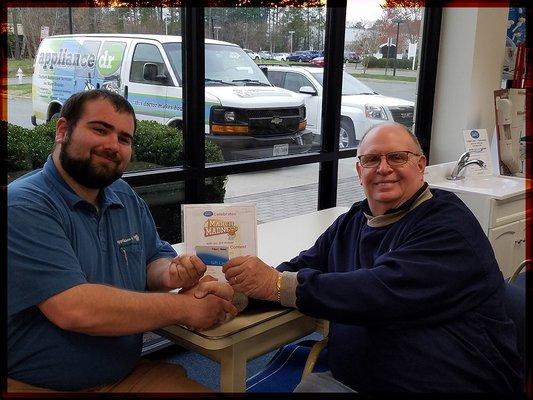 Ron Clifton, Store Manager, congratulates Josh of Appliance Doctor for winning our March Madness Contest