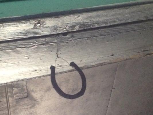 An old horseshoe hanging from the ceiling for good luck. Obviously the reason for his success.