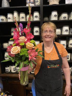 Owner, Linda, with a beautiful arrangement.