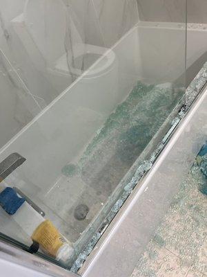 Photo shows glass shards in the bathtub