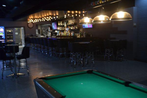 Quater-operated pool tables near main bar