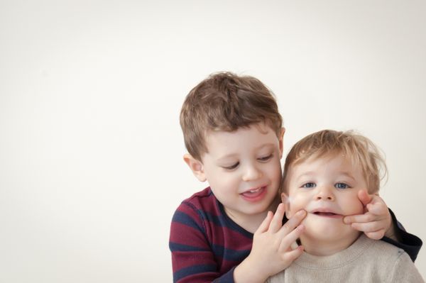 Helping his brother smile for the camera