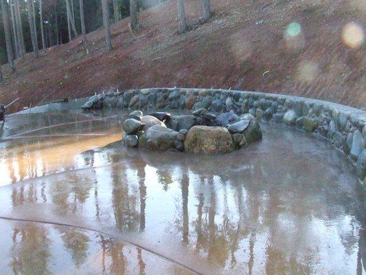 river rock retaining wall stamp colored concrete deck and large boulder fire pit design source natural river rock and install