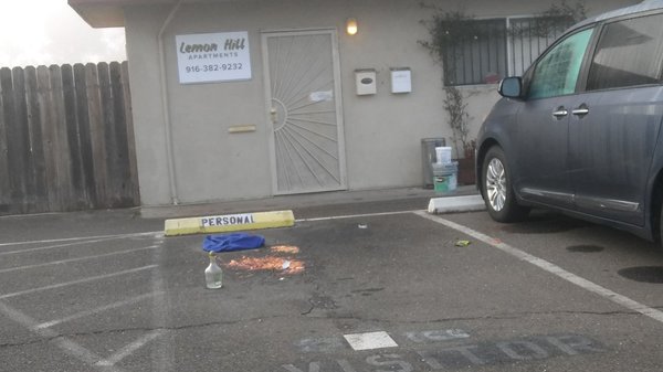 Vomit and an empty liquor bottle in front of the office