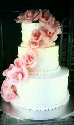 Wedding Cake with Pink Roses Cascading from top down the side