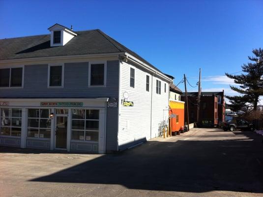 The building # out front is 175 High St. The orange wall around the side has the shop door (165 High St)