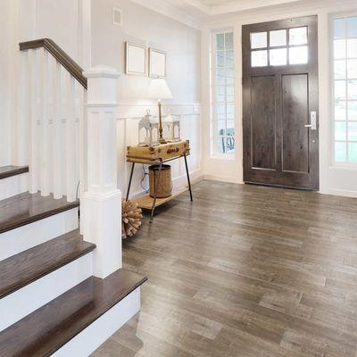 Vinyl flooring with shades darker on the staining for the doors and stairs.