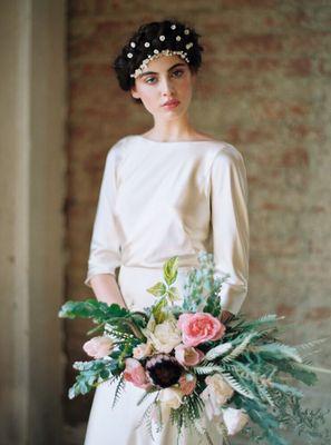 A styled shoot for a whimsical bride with roses, tulips and protea and wild greens.