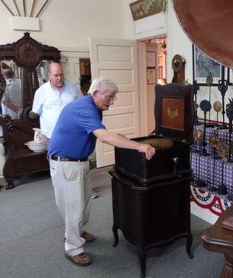 Museum manager Colon Ballance demonstrates a beautiful Regina music box.