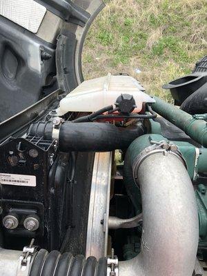 The blown hose on the white big truck .