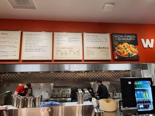 Panda Express menu board and kitchen