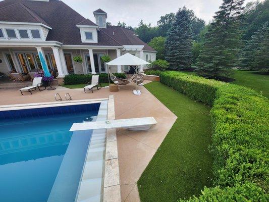 Put artificial grass around your pool