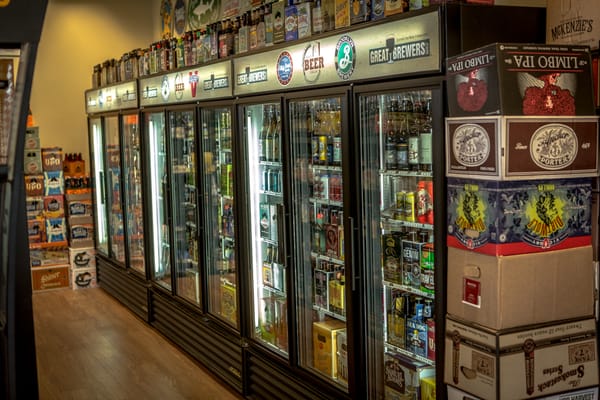 Three '3 door merchandiser' purchased by Craft Beer Cellars helps display their extensive options for  customers to enjoy.