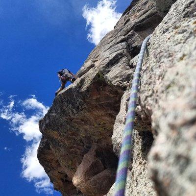 Guide Seth Hogan leading the crux pitch of Idiot Wind out on Sundance Buttress, Lumpy Ridge.