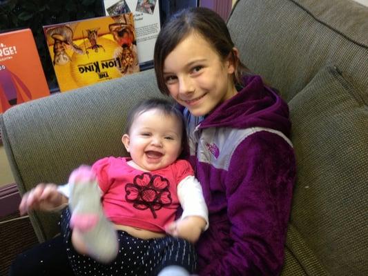 One of our lovely patients holds office baby Zoey!