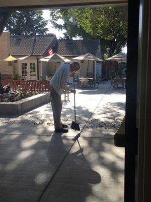 Resident keeping busy, enjoying spacious patio/ atrium in his home, near the parrot