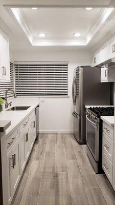 Newly refreshed Kitchen. Demo, Tiling, Recessed lighting, Crown Molding, Baseboards, Cabinets, Counter top, Plumbing, & Sink/Range Backspla