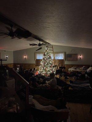 People sleep under the Christmas tree.