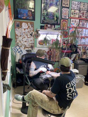 Person getting tattoo.