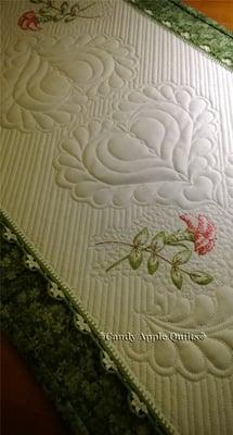 Crocheted edging and hand-embroidery adorn this vintage quilted linen table runner