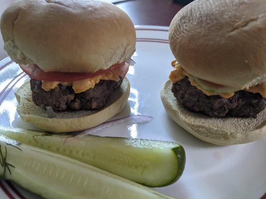 Two Grillo's pickle spears with my cheeseburgers