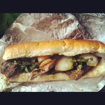 Lime/garlic/chili mojo flank steak sandwich w/ grilled onions