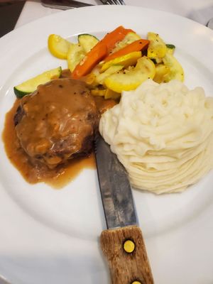 Filet in demi glaze, mashed potatoes, and vegetables.