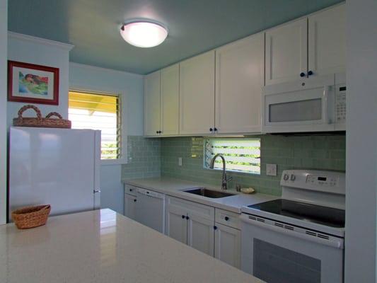 Oceanfront Unit 9 Kitchen... Love this kitchen - from the glass tiles to the SPA colors... so serene!!  Hulanow.com