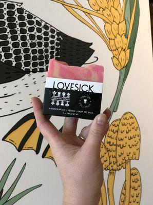 Lovesick Bar Soap from Perennial Soaps in front of our mural featuring iconic flora and fauna native to Wisconsin.