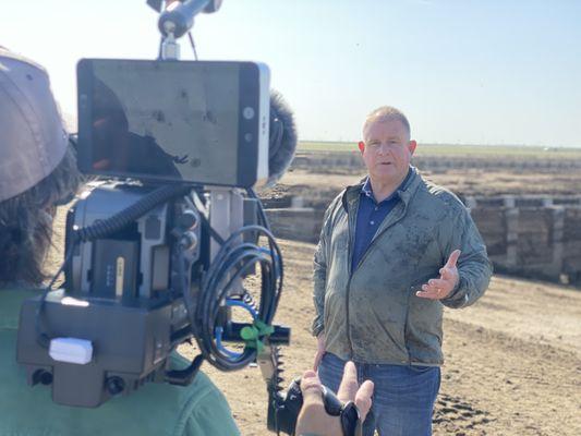 Filming an interview on location at a commercial dairy in Fresno, CA.