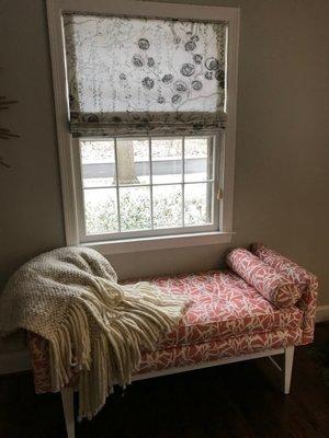 Linen floral roman shades, big chunky throw and midcentury bench