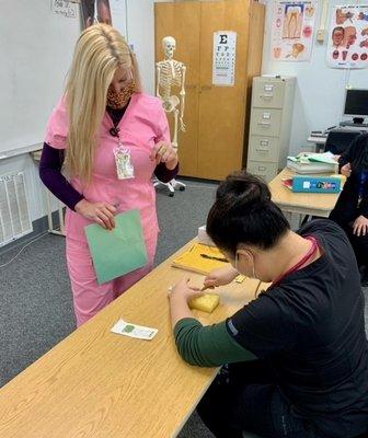 Our CMA students working on staple removal techniques.