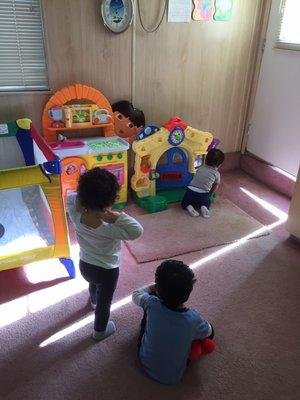 Inside our daycare in Granada Hills. Children playing inside a clean and supervised room.
 Thise  kids are learning and playing inside.