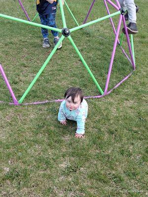 My daughter crawling in the grass