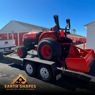 Tractor with box blade. We installed a hydraulic top and tilt so you can adjust pitch and change from cut to float on the fly.