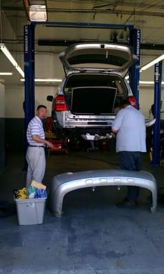 Scott and my insurance guy taking my car apart for insurance estimate. Anthony from Framers is awesome.