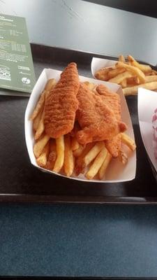 3 pc chicken fingers on a bed of fries with a combo side of fries in the background