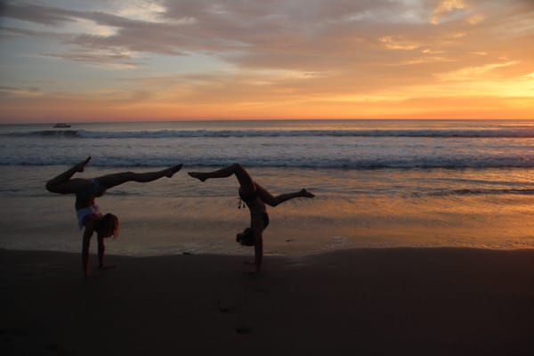 Founders Sam Vetrano and Tina Bock playing on the beach at the latest 200-hour Ashtanga Yoga Teacher Training in Nicaragua!