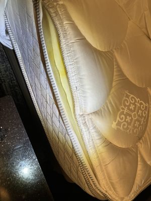 worn mattress and ripped mattress cover