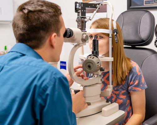 Dr Jason Foote performing a comprehensive eye exam on an adult patient