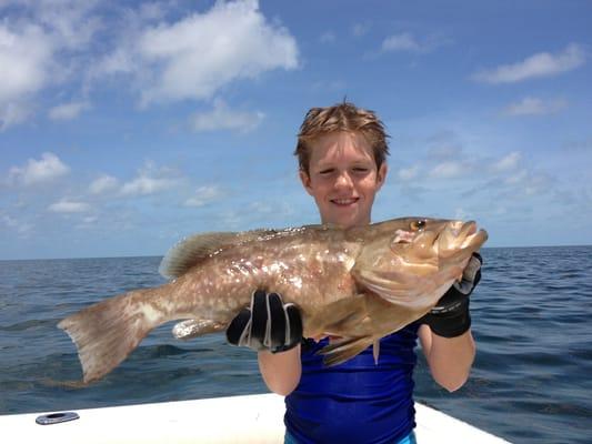 Tucker with a big red grouper that he shot while on a charter with Two Conchs out of Big Time Bait and Tackle.