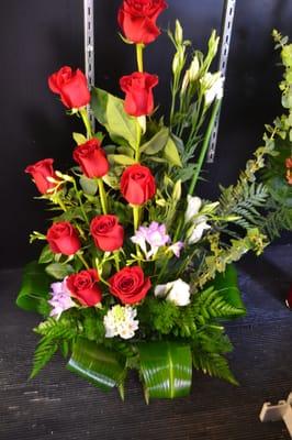 Floral Arrangment with red roses, bells , white roses green leaves