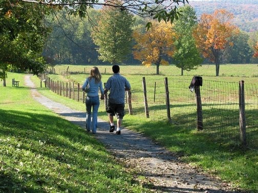 A couple enjoys the beautiful Deerfield landscape from the Channing Balake Meadow Walk.