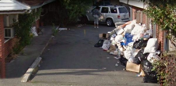 Close up of side entry - Notice the open windows just above the trash bags? Yes, the trash actually smells better than that room.