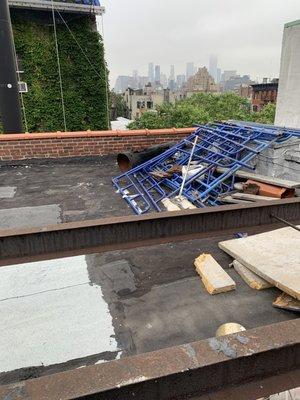 This is extremely dangerous.   The roof clearly is not for public use but the construction debris is not allowed to be stored on the roof.