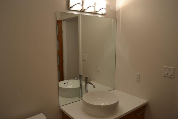 1/4" thick clear mirror installed into bathroom.