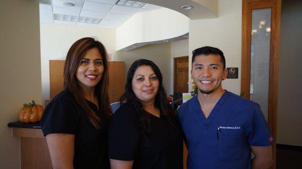 Dr. Hector M. Gomez with his front office staff and assistant